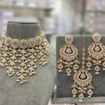 The beautiful white transparent stones clearly arranged, embossed vibrant colorful polki beads stringed by the pearls