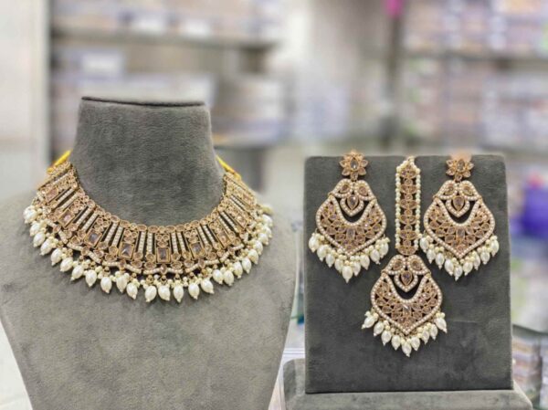 The beautiful white transparent stones clearly arranged, embossed vibrant colorful polki beads stringed by the pearls